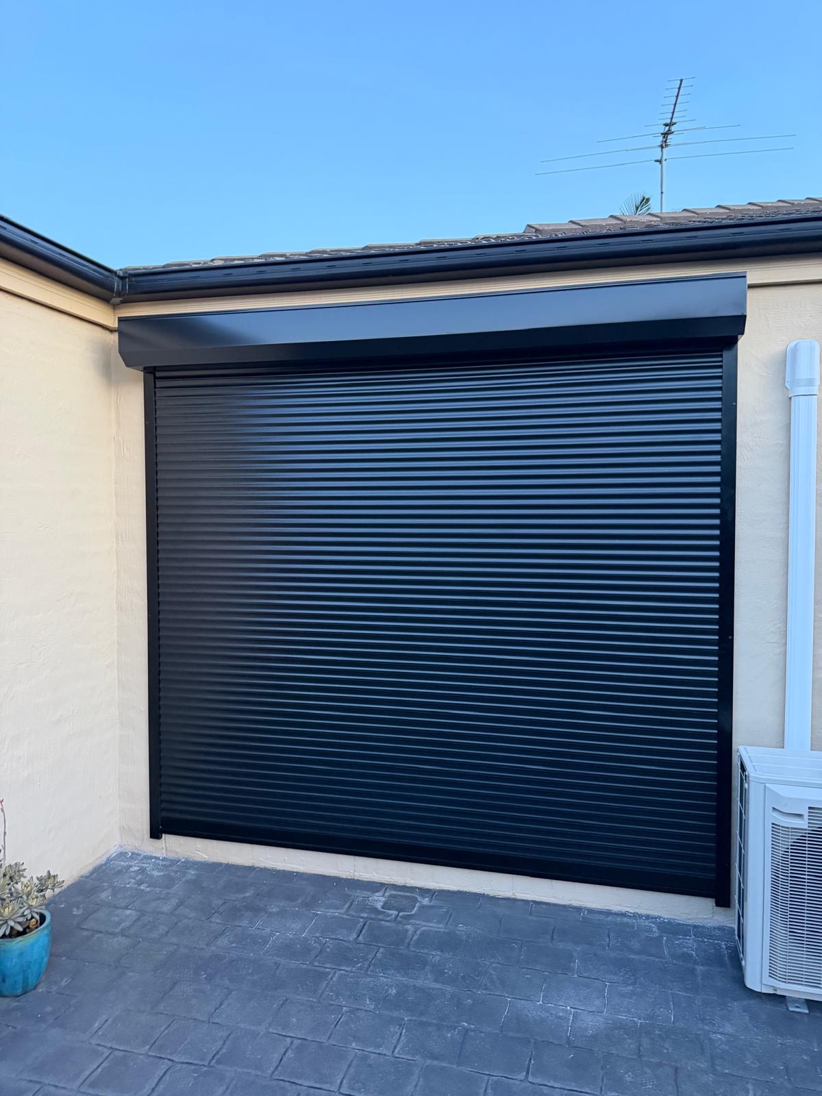 Black roller shutter installed on residential home Melbourne